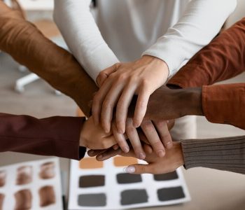 high-angle-people-putting-hands-together_23-2149636275